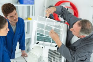 Technicians checking the AC unit