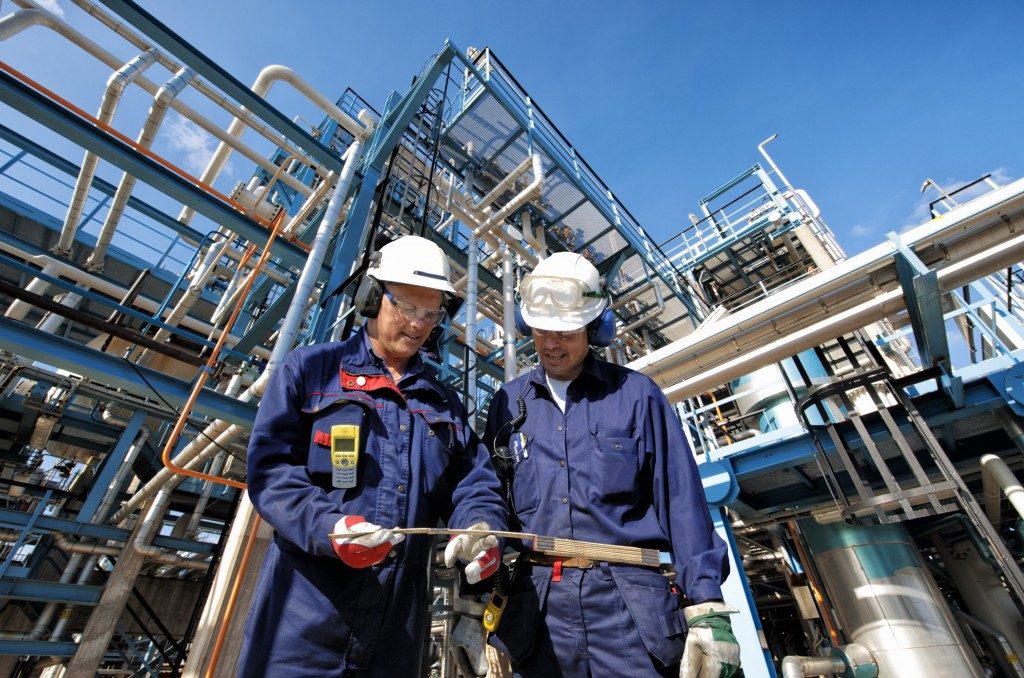 Two workers in oil refinery