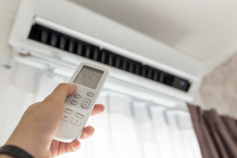 Hand holding airconditioner remote