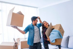 couple carrying boxes, moving together