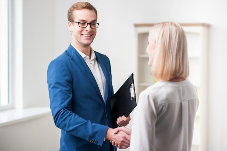 Real estate agent handshaking client