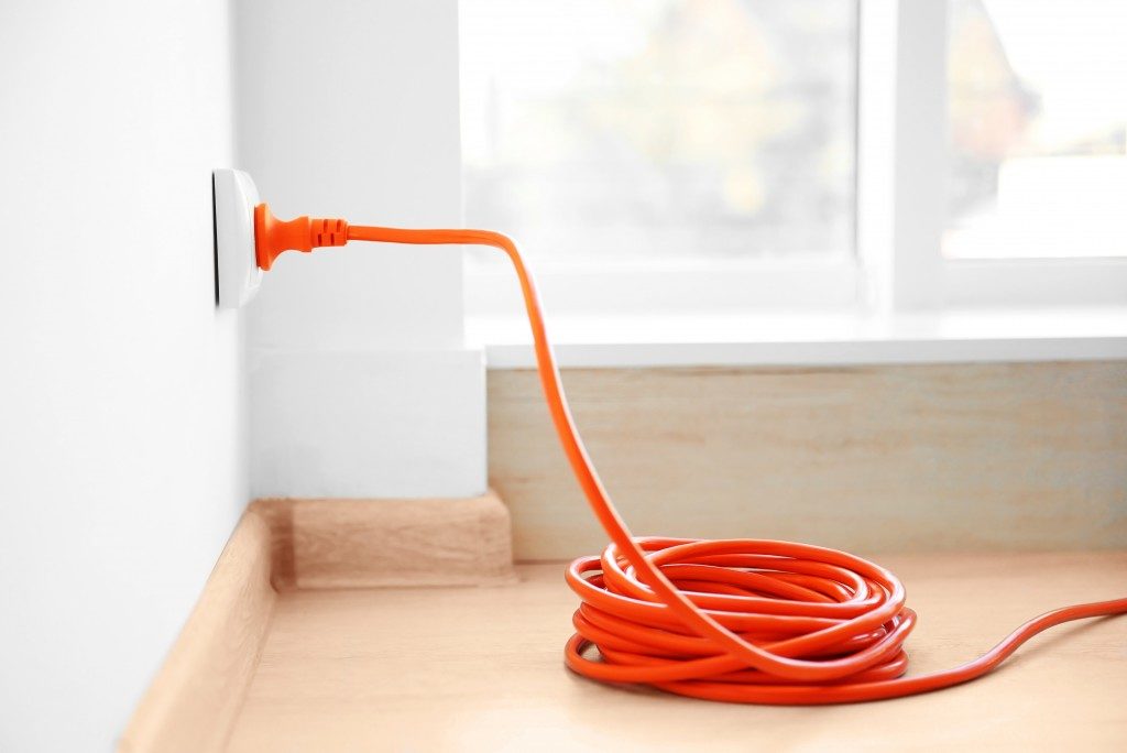 orange plug in an electrical outlet