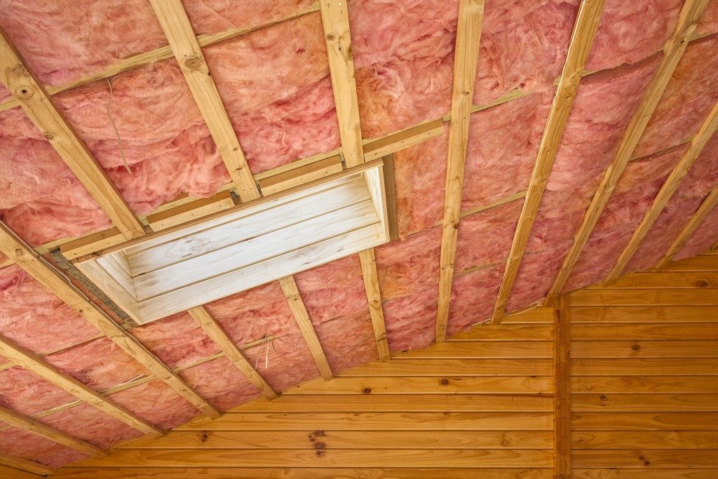 Fibreglass insulation installed in the sloping ceiling of a timber house
