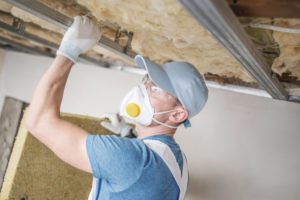 Worker installing insulation