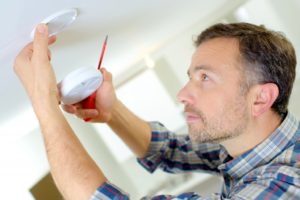 Man installing smoke detector