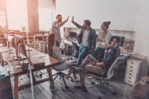 group of people cheering in an office