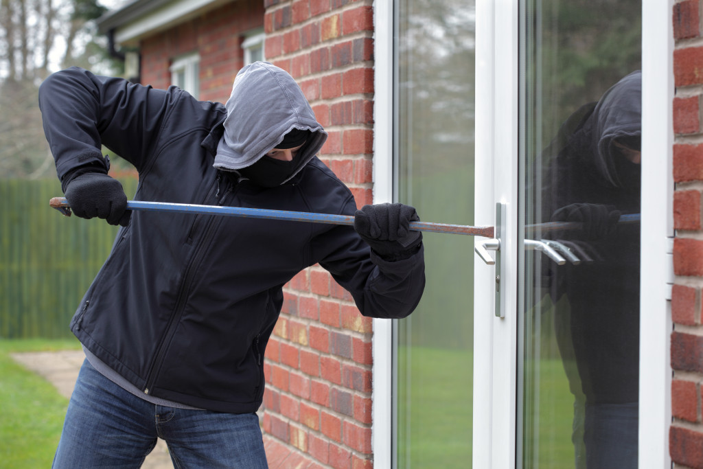 Burglar breaking into a house window