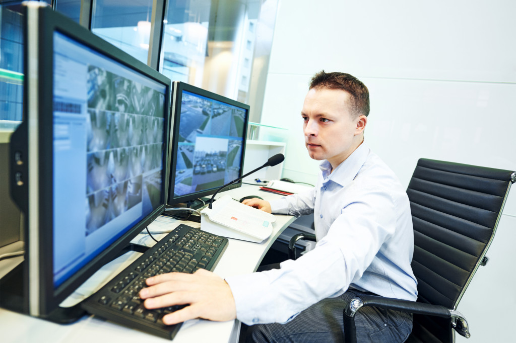 Man monitoring a security surveillance system