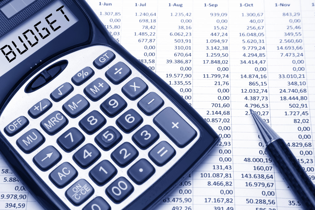a calculator, pen, and a spreadsheet