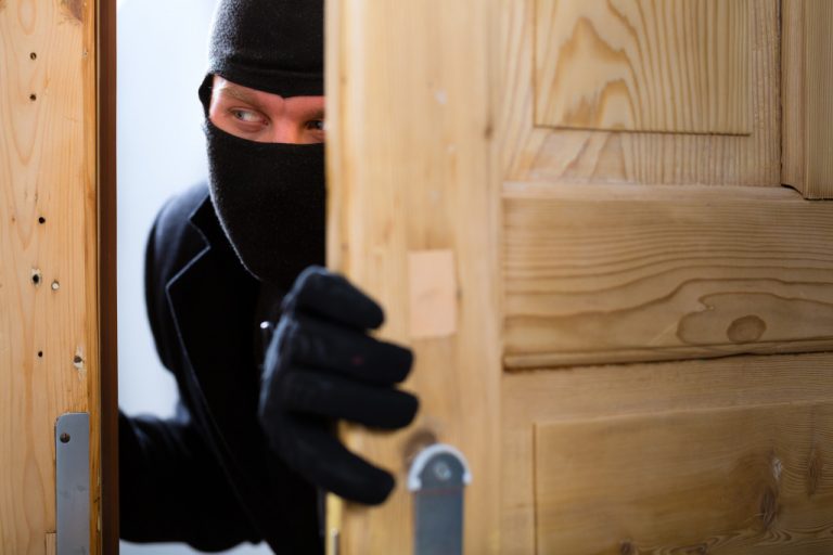 Burglar sneaking in through the door