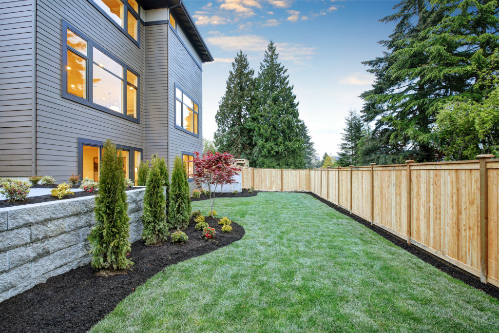 Portrait of a house yard well maintain and clean with wooden boundary 
