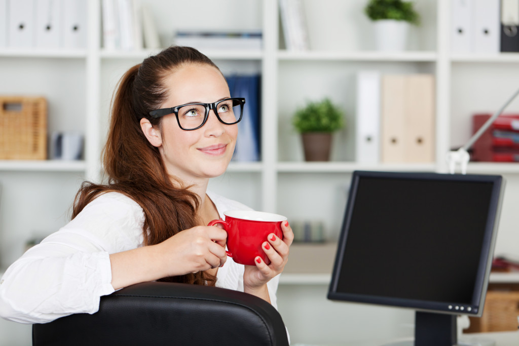 Businesswoman having a coffee breaks while thinking inside the office
