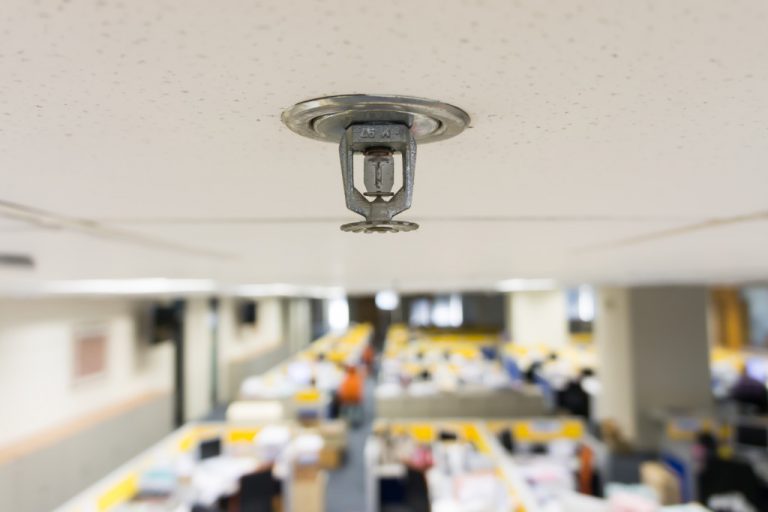 A sprinkler system on a ceiling of an office