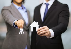 agent holding a house with key