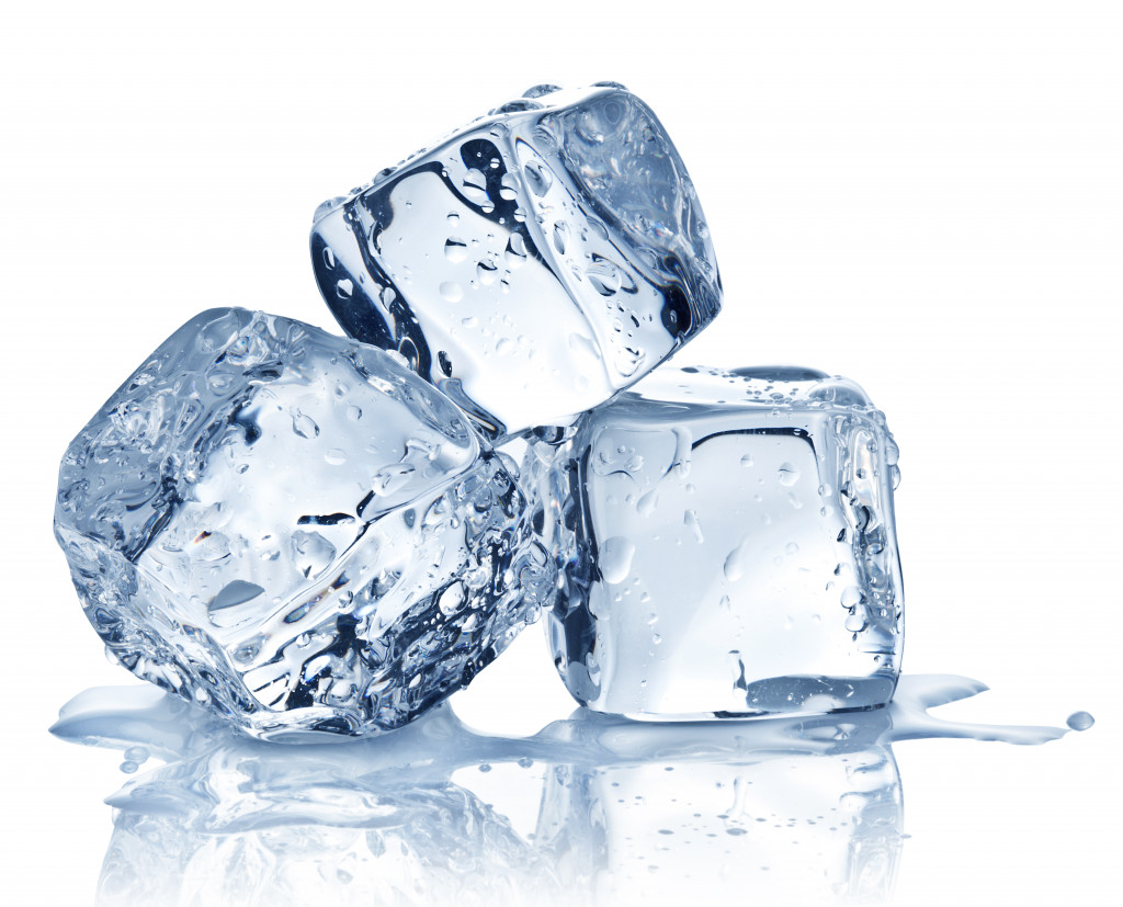 three ice cubes melting in white background