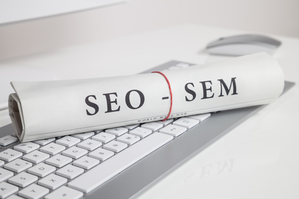 SEO and SEM concept on paper rolled up