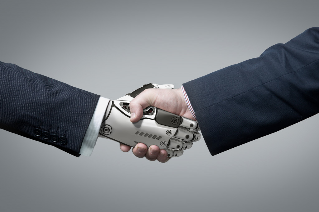 human hand shaking robot hand concept of artificial intelligence
