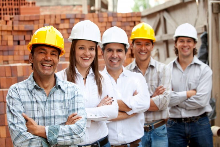 a group of contractors wearing hard hats smiling