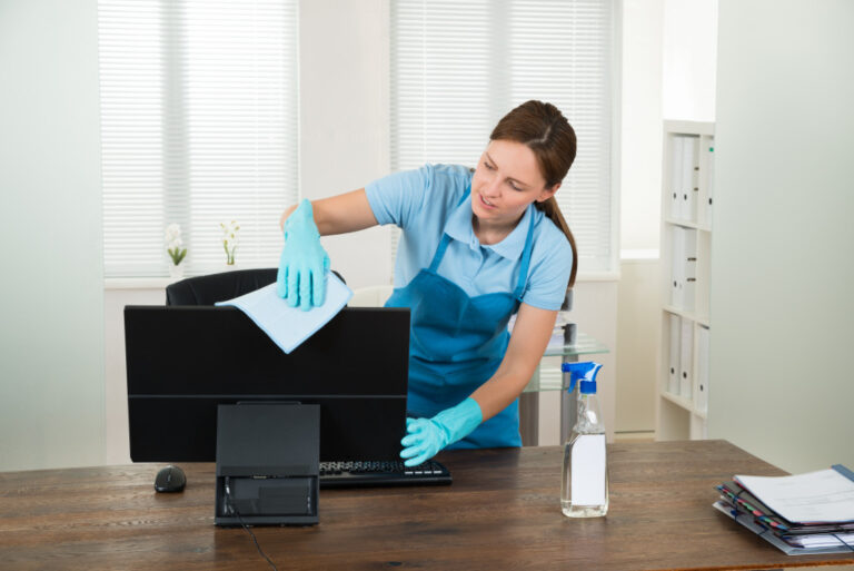 woman cleaning the desktop in the office