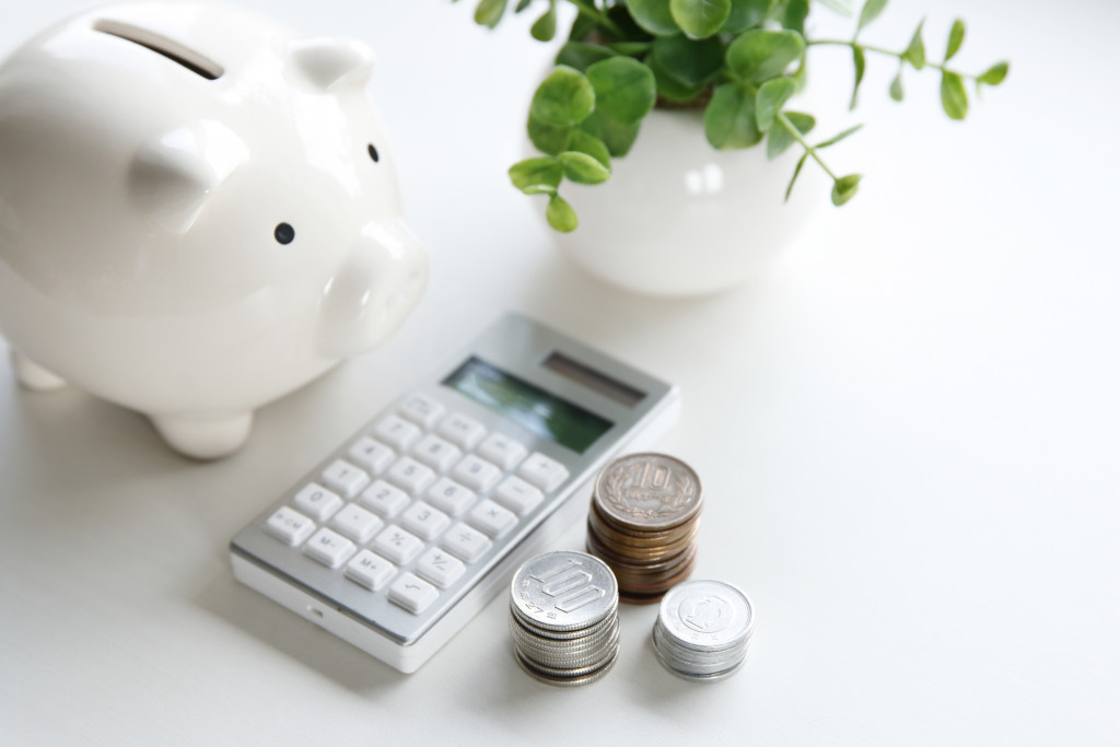 Piggy bank, calculator, and coins