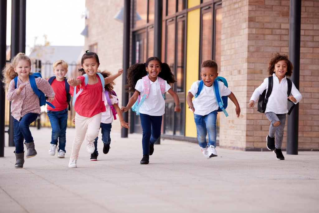 preschool students running at the school hallway