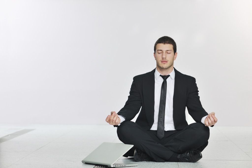 man in suit relaxing, stress control concept