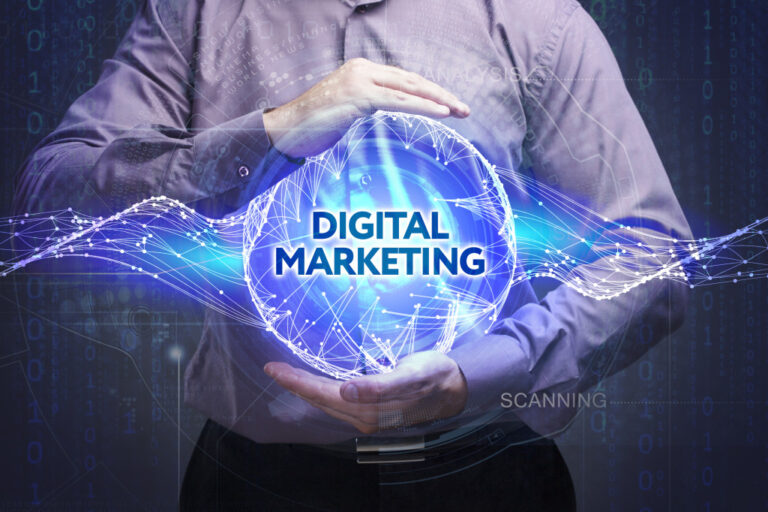 A businessman holding a blue sphere with the words DIGITAL MARKETING
