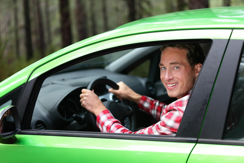 man smiling in the car goin for a drive